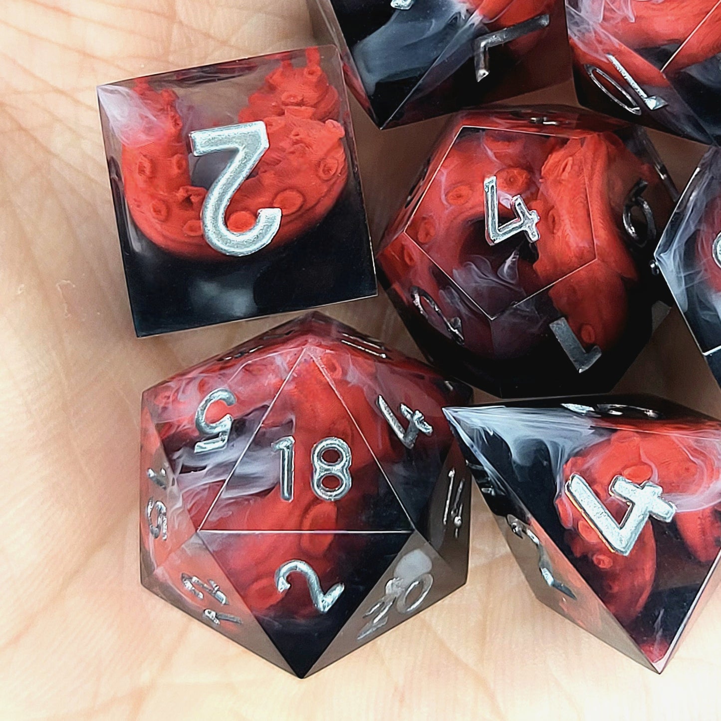 Handcrafted sharp edge resin dice featuring eerie red tentacles suspended in dark transparent resin, surrounded by ghostly white mist and finished with metallic silver numbers