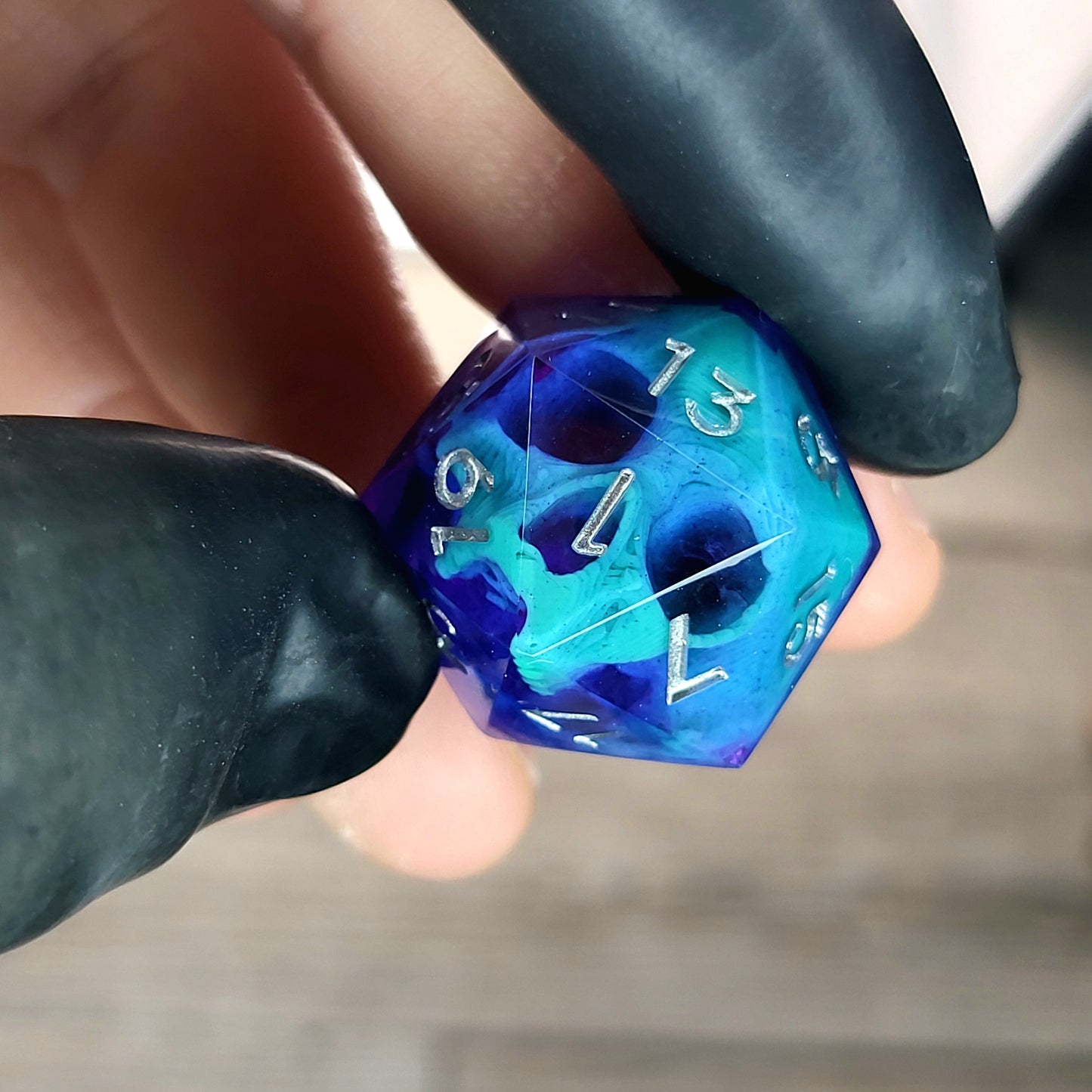 This is a single set of one D20 DnD die with a green skull inside , purple resin and silver numbers