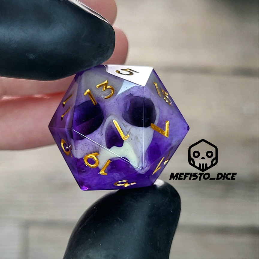 This is a single set of one D20 DnD die with a light brown skull inside , purple resin and gold numbers