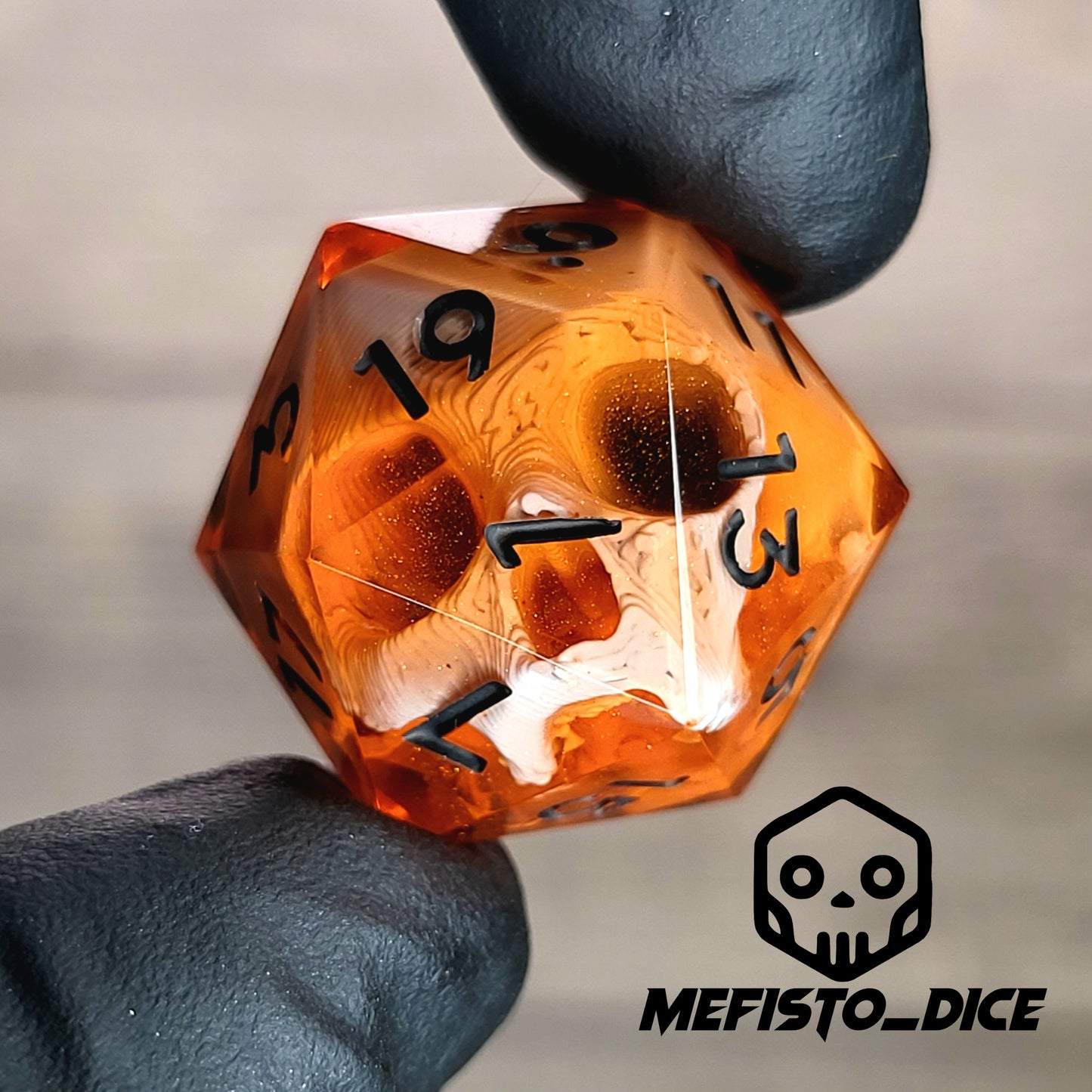 This is a single set of one D20 DnD die with a white skull inside , orange resin and black numbers