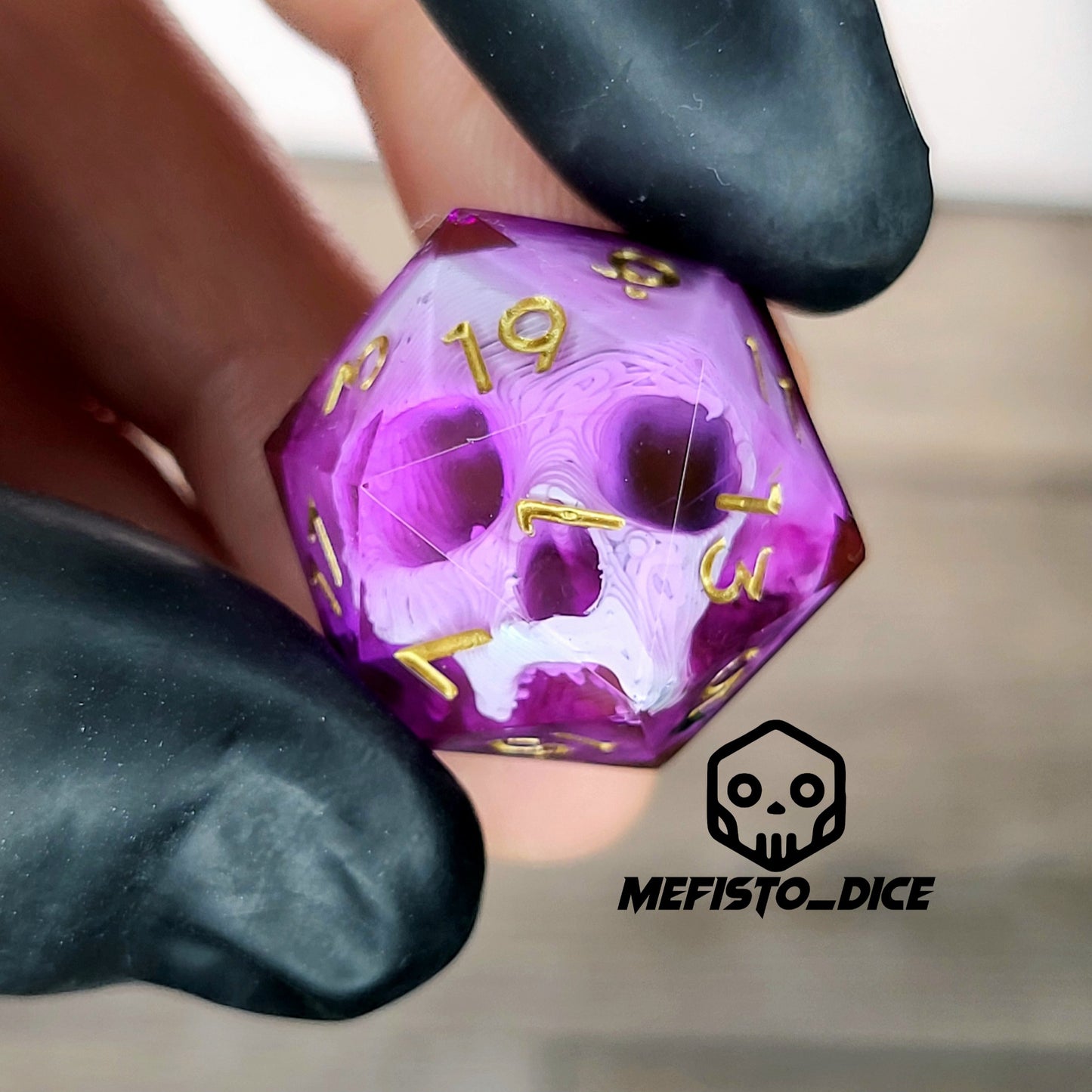 This is a single set of one D20 DnD die with a white skull inside , pink resin and gold numbers