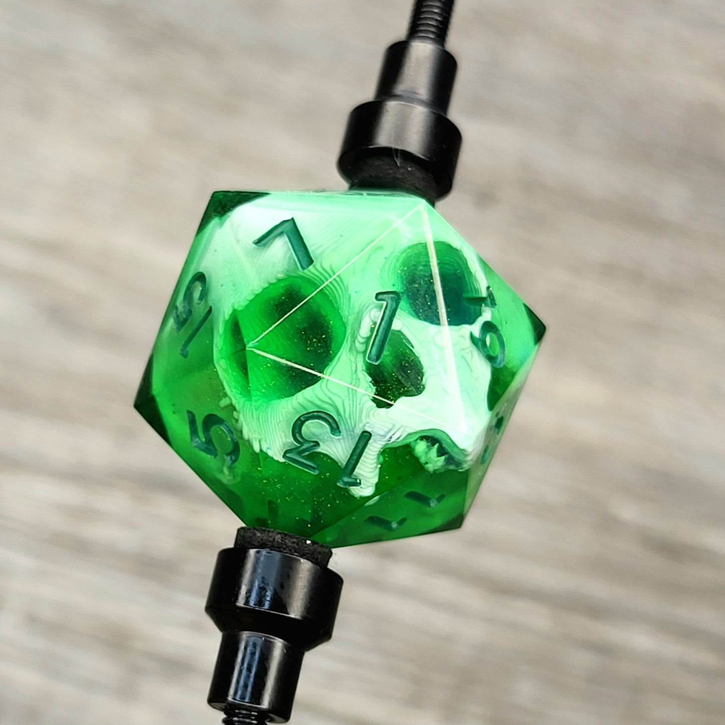 This is a single set of one D20 DnD die with a white skull inside, green resin and green numbers for role playing games