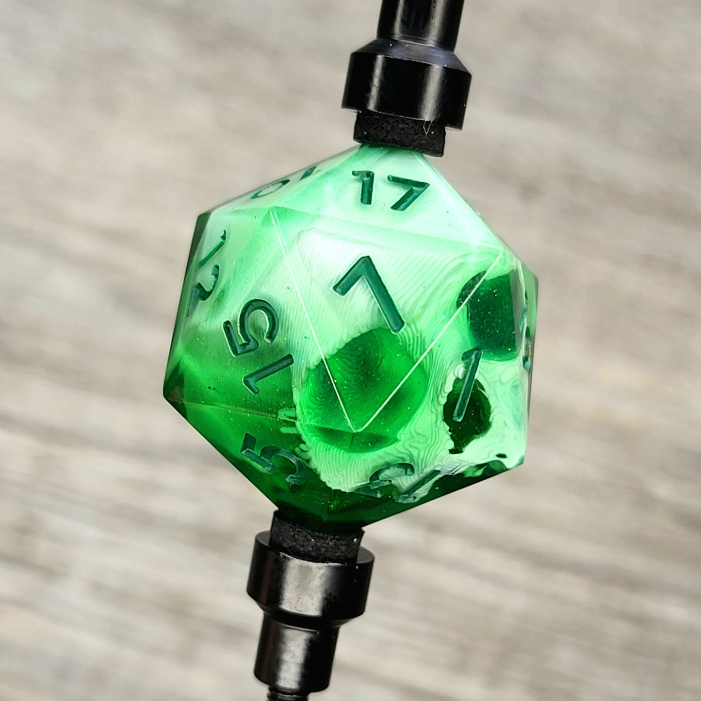 This is a single set of one D20 DnD die with a white skull inside, green resin and green numbers for role playing games