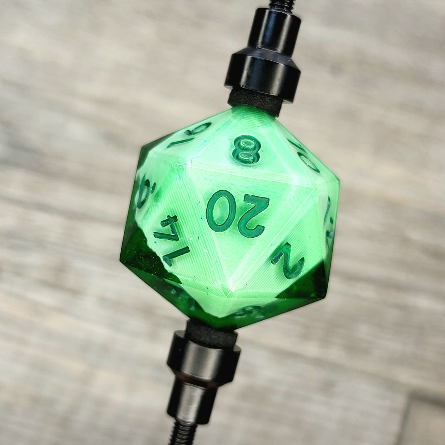 This is a single set of one D20 DnD die with a white skull inside, green resin and green numbers for role playing games