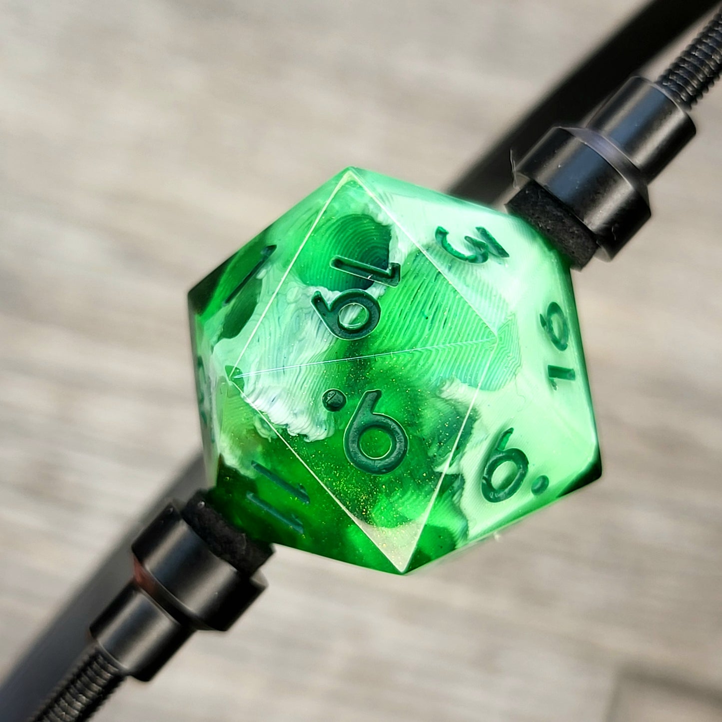 This is a single set of one D20 DnD die with a white skull inside, green resin and green numbers for role playing games