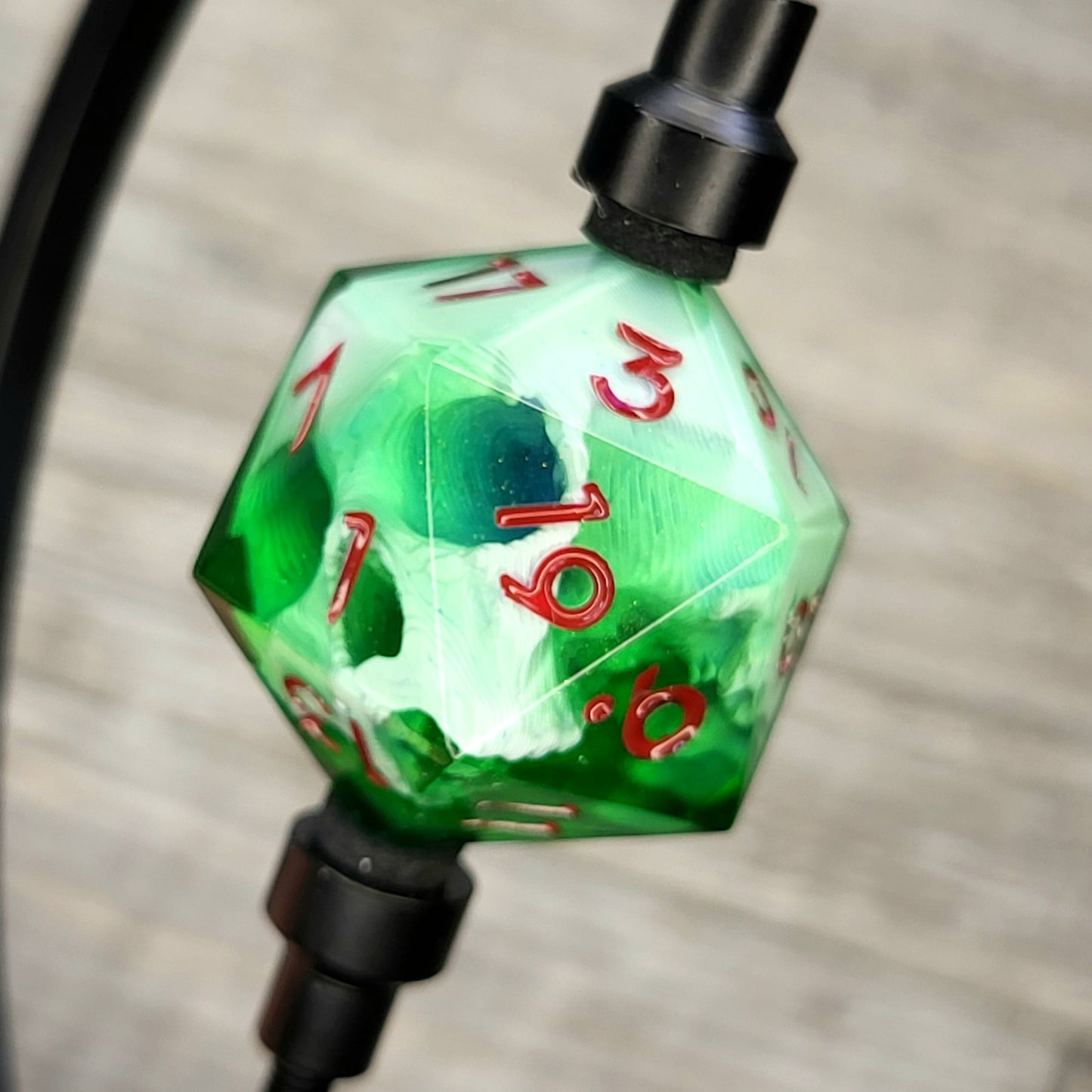 D20 single die with a white skull inside, red numbers, green resin for role playing games, DnD, dungeons and dragons, board games