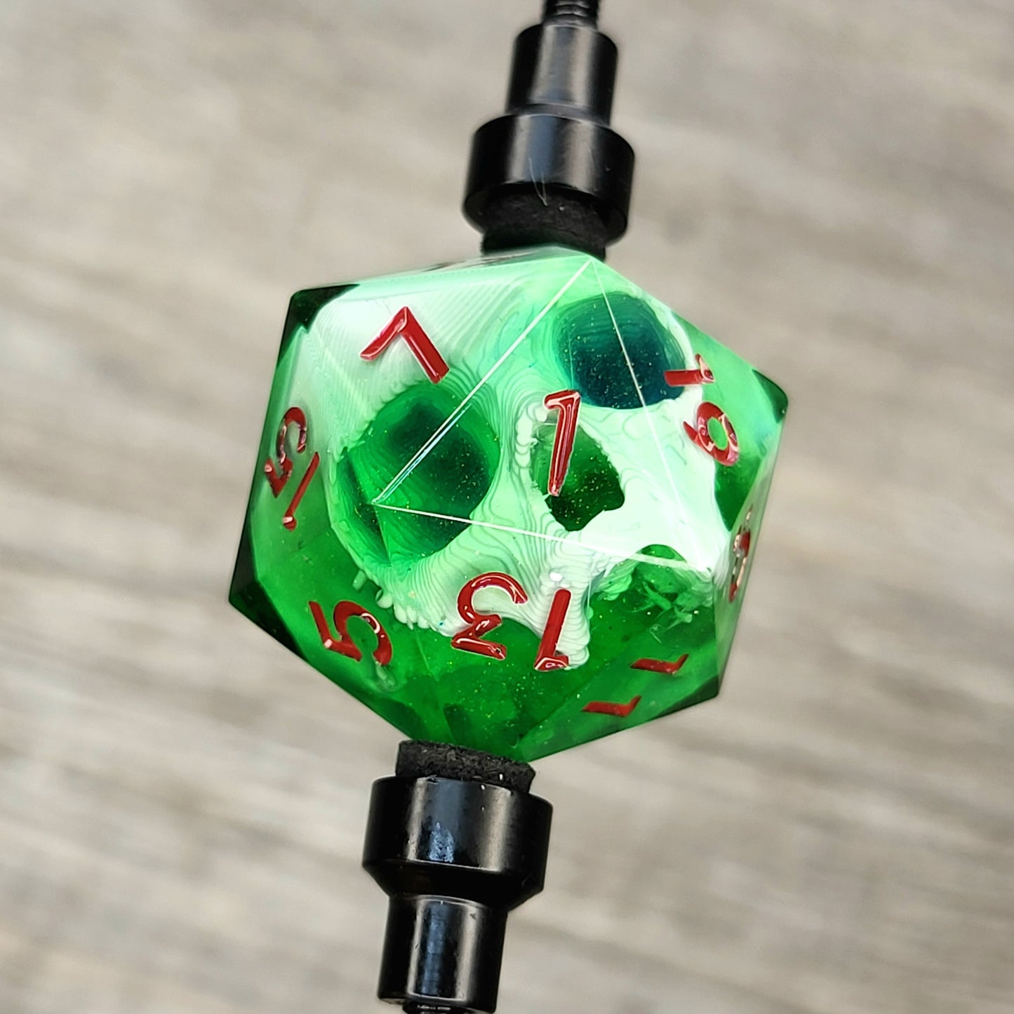 D20 single die with a white skull inside, red numbers, green resin for role playing games, DnD, dungeons and dragons, board games