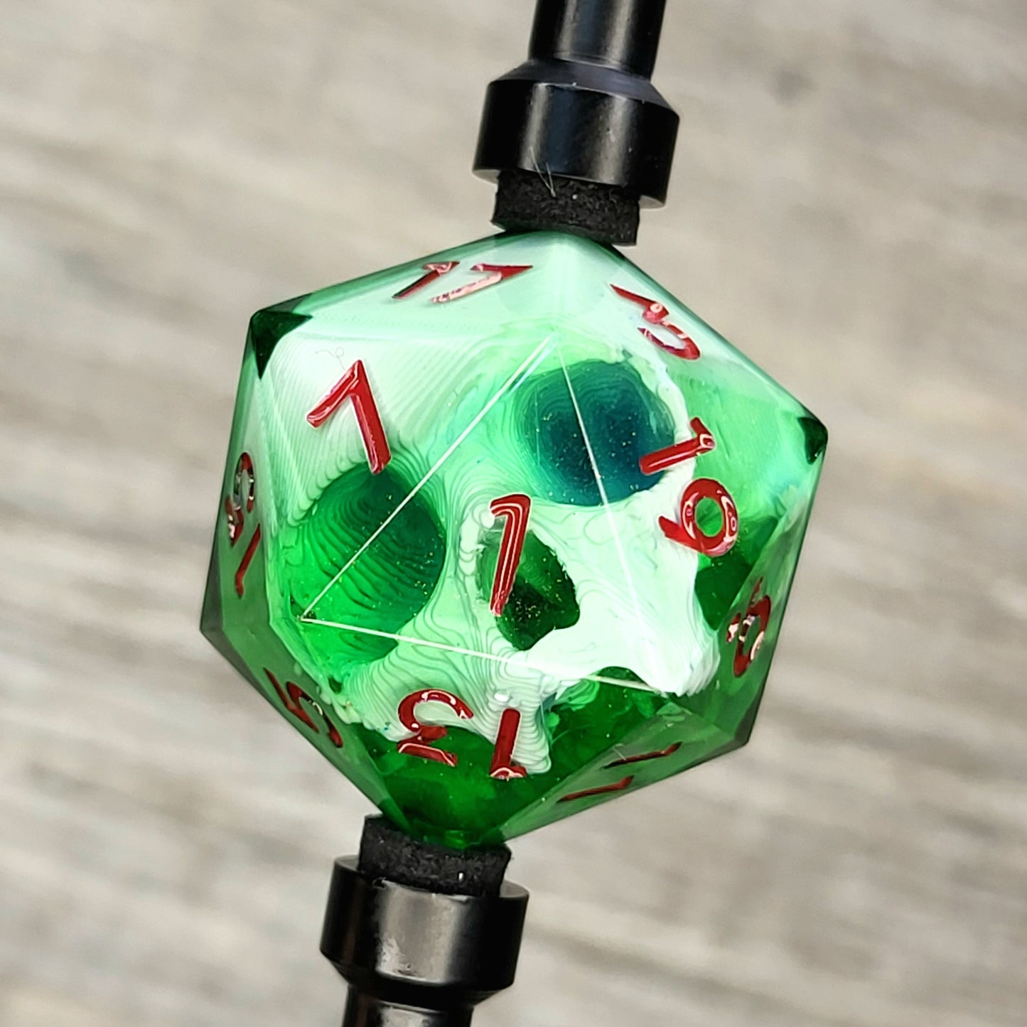 D20 single die with a white skull inside, red numbers, green resin for role playing games, DnD, dungeons and dragons, board games