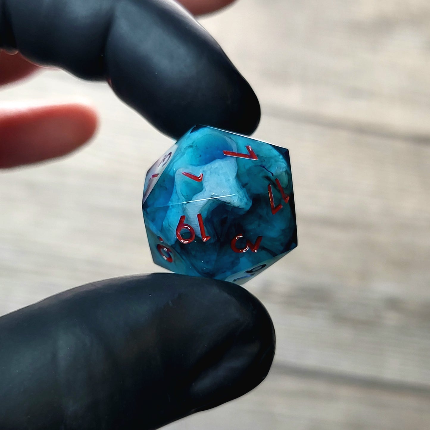 This is a single set of one D20 DnD die with a white fluo skull inside , dark resin and red numbers