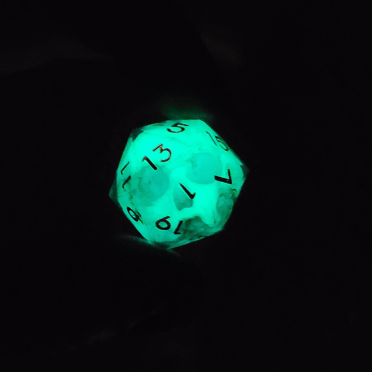 This is a single set of one D20 DnD die with a white fluo skull inside , dark resin and red numbers