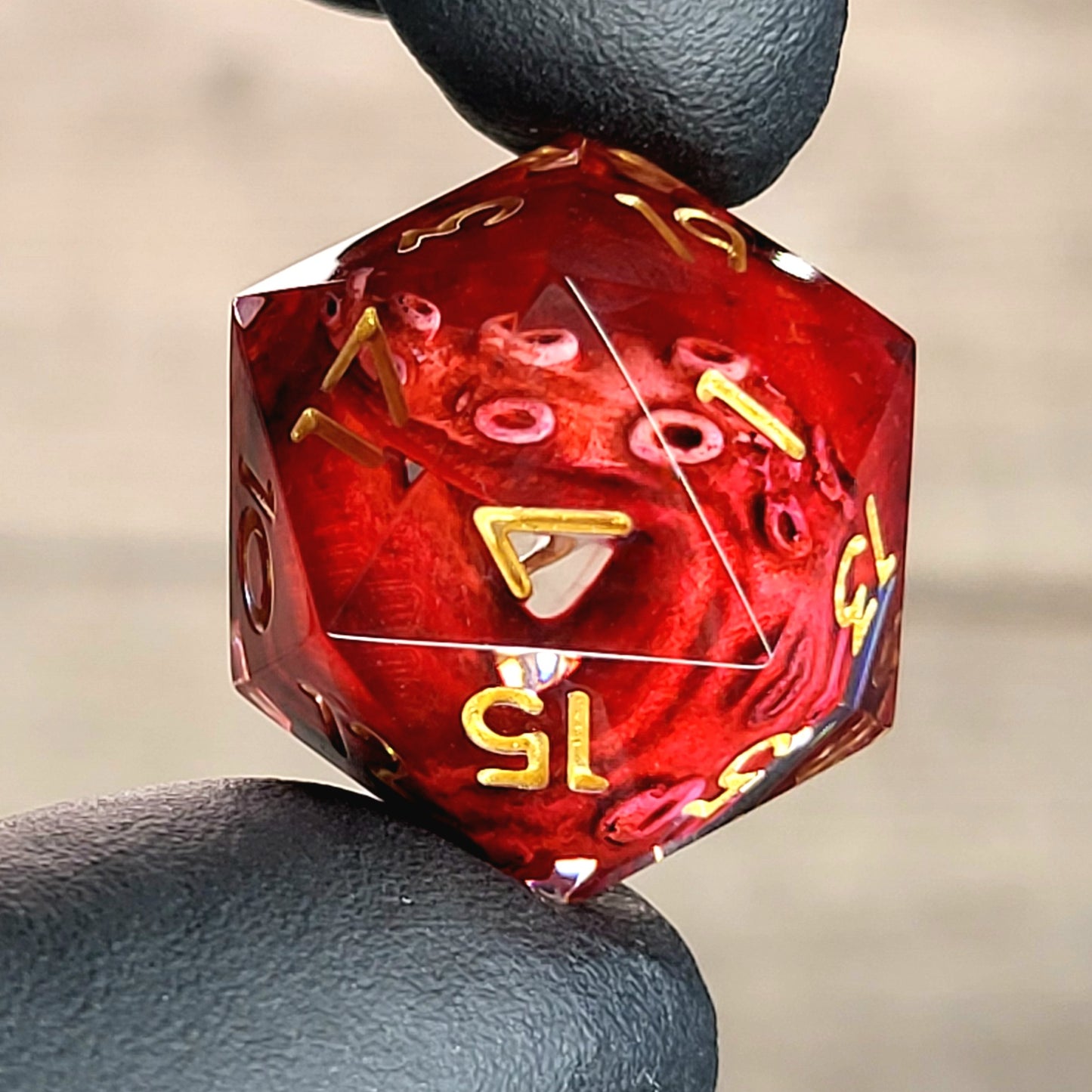 D20 dice with red tentacles inside and gold numbers for play dnd , dungeons and dragons