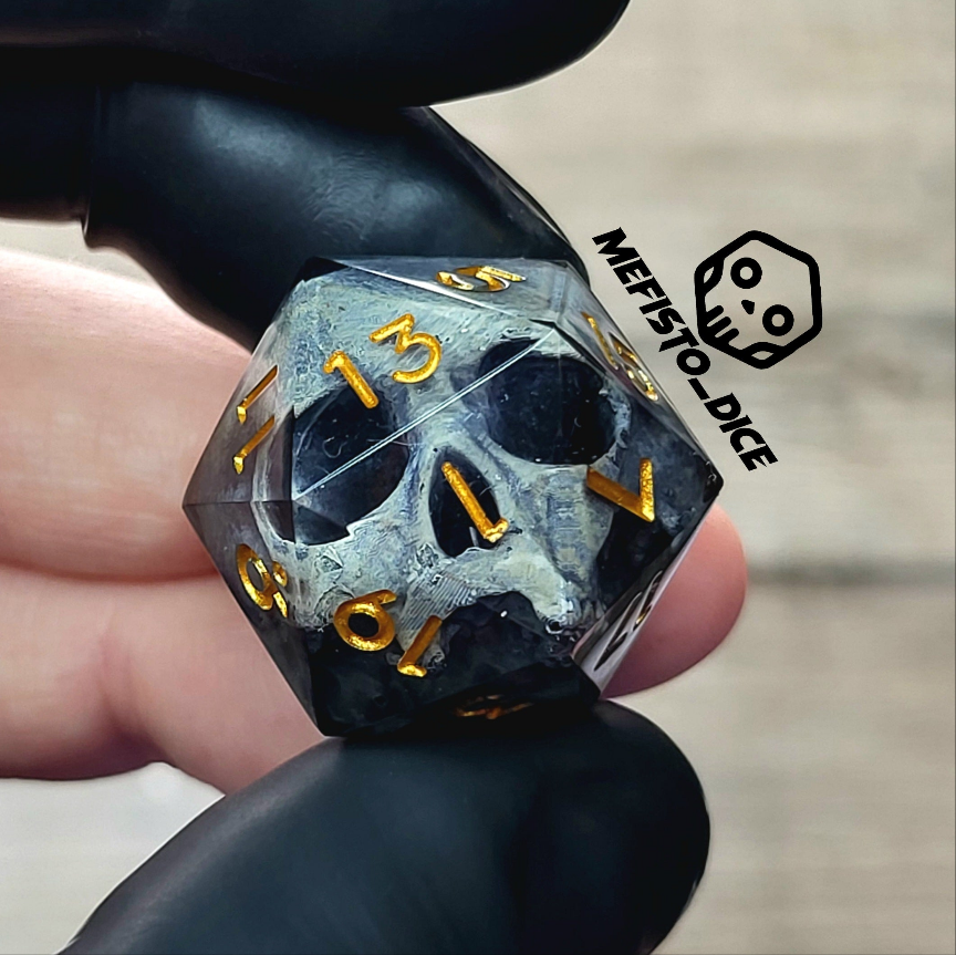 This is a single set of one D20 DnD die with a grey stone skull inside , black resin and gold numbers