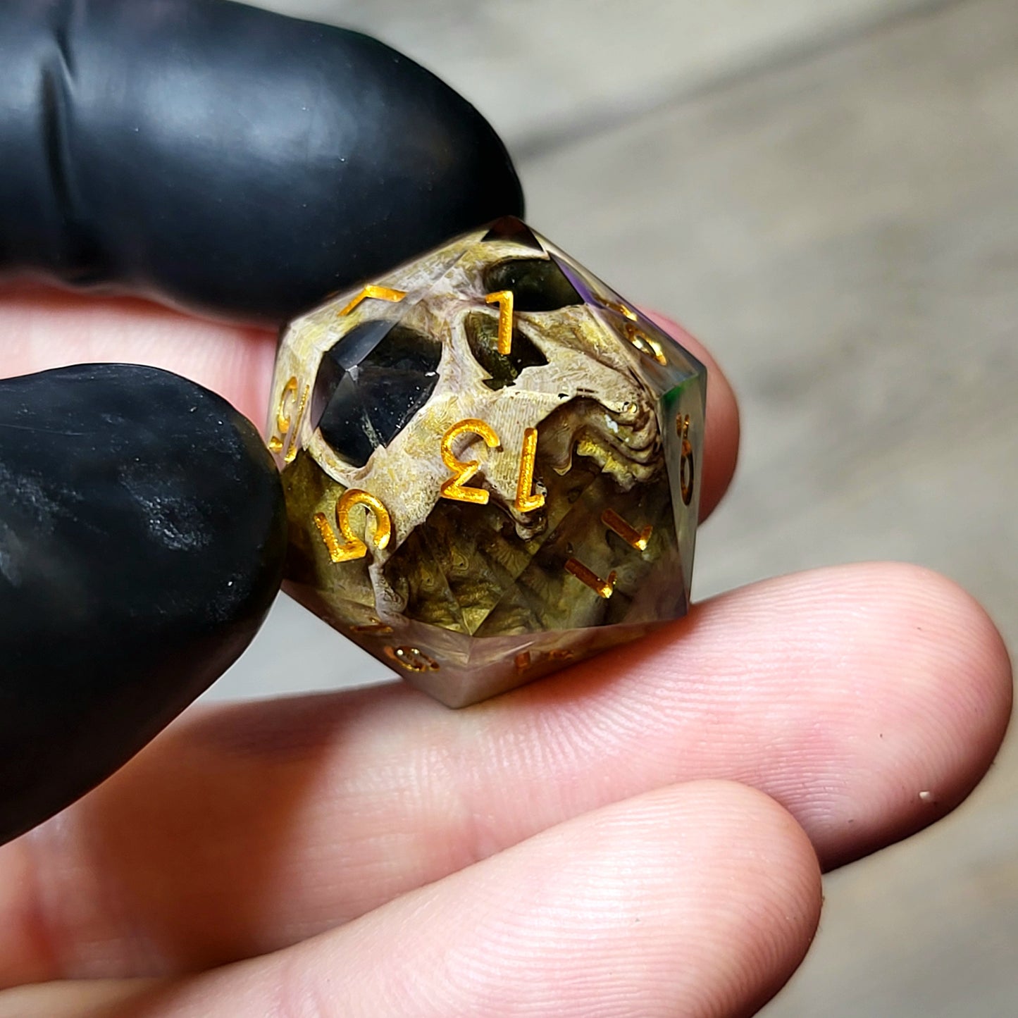 This is a single set of one D20 DND die with a light brown skull inside ,black resin and gold numbers