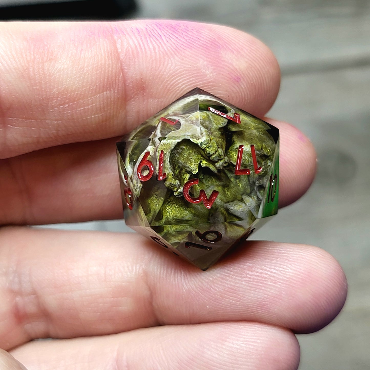 This is a single set of one D20 DND die with a light brown skull inside ,black resin and red numbers