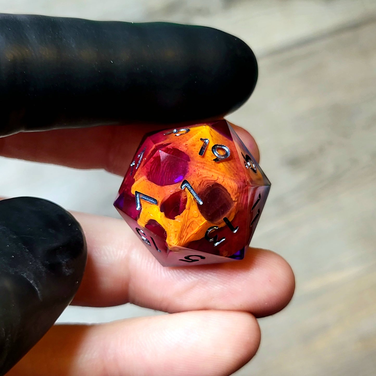 This is a single set of one D20 DND die with a orange skull inside ,purple resin and black silver numbers