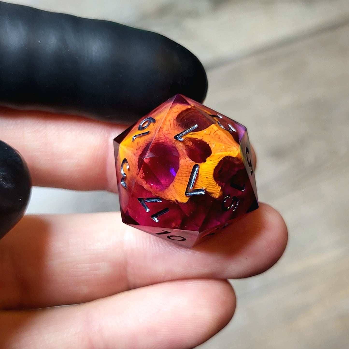 This is a single set of one D20 DND die with a orange skull inside ,purple resin and black silver numbers