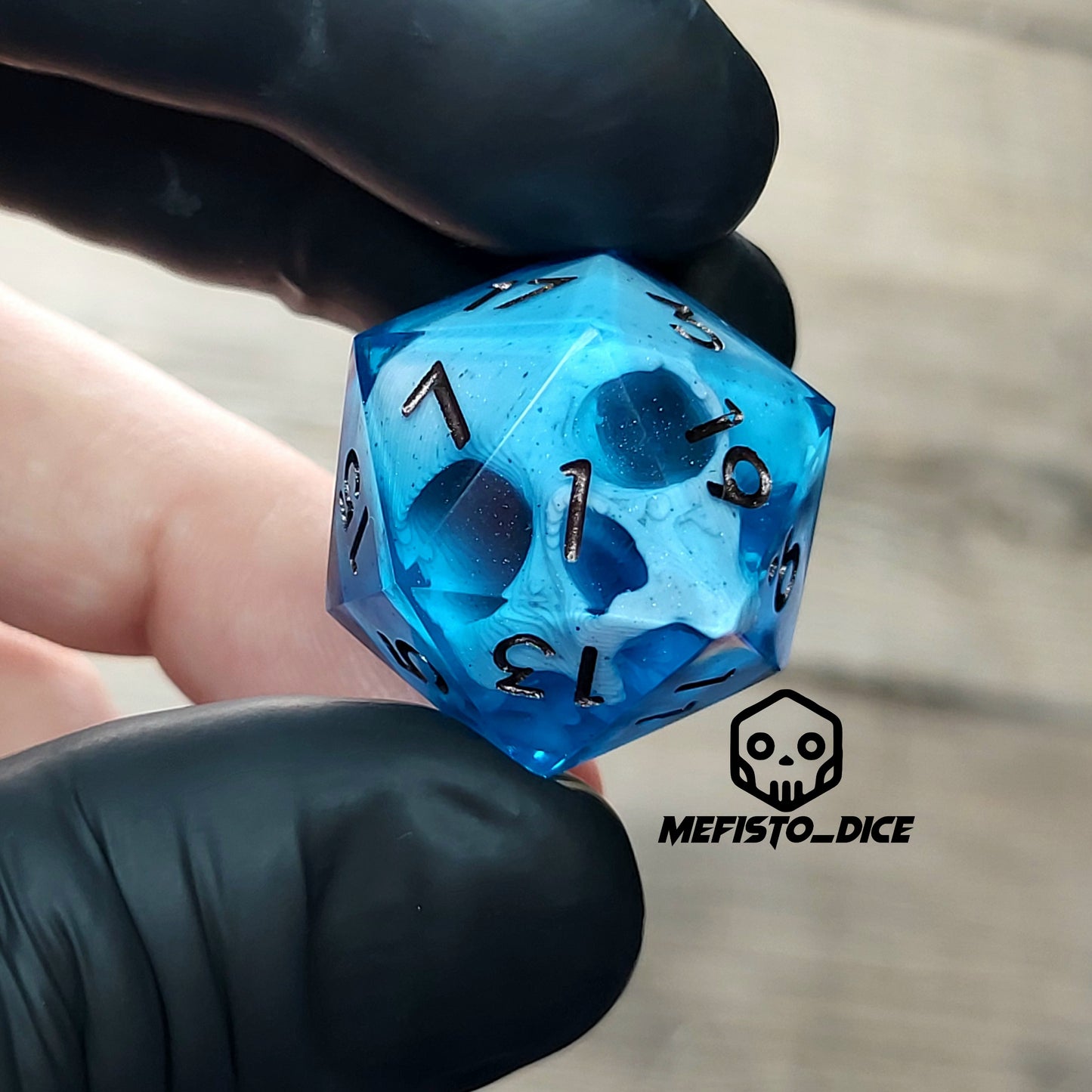 This is a single set of one D20 DnD die with a white skull inside ,blue resin and metal dark numbers