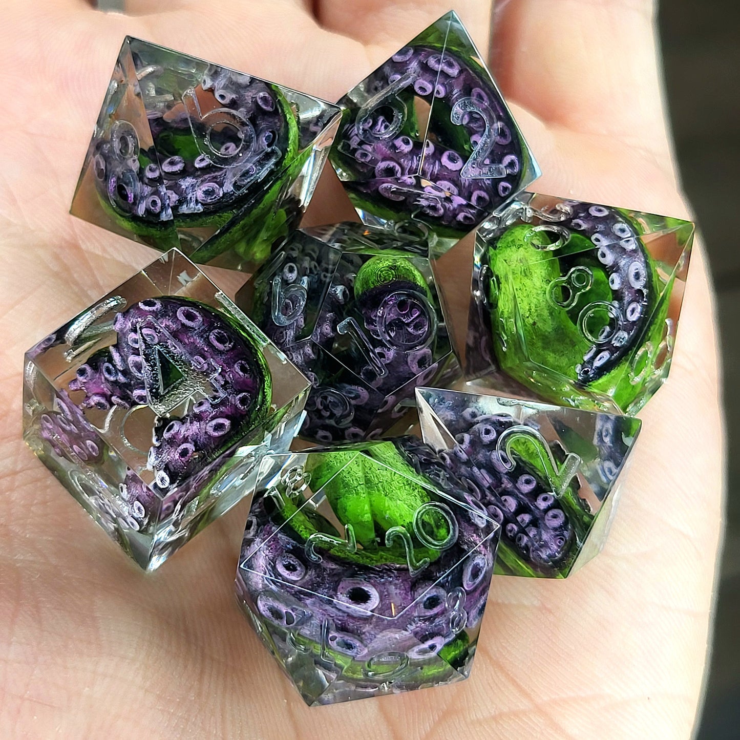 Dice set with green tentacles inside for role playing games, dungeons and dragons, board games