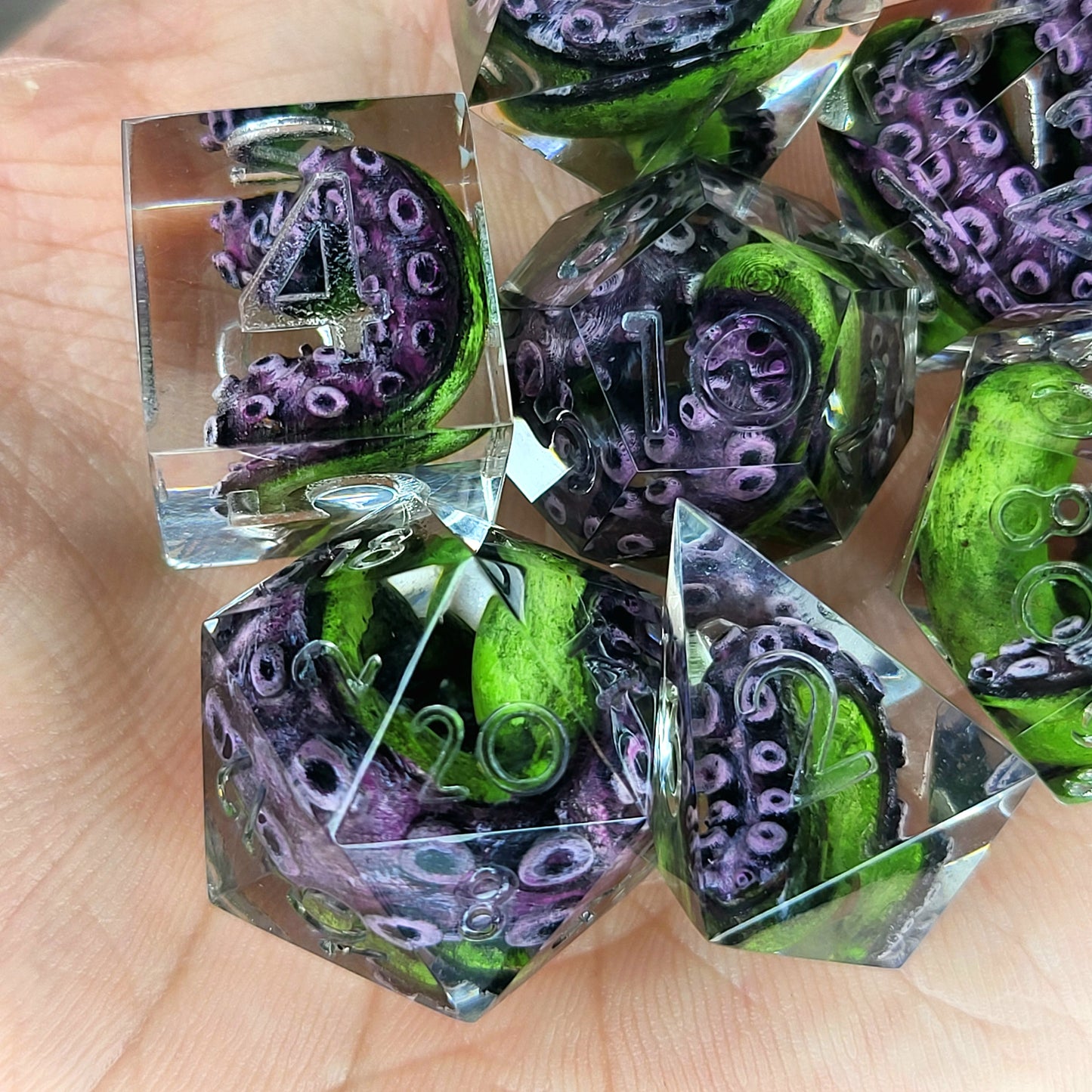 Dice set with green tentacles inside for role playing games, dungeons and dragons, board games