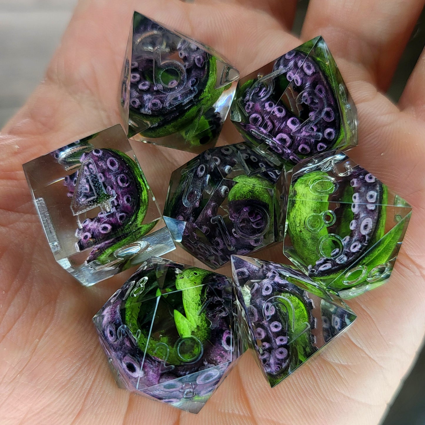 Dice set with green tentacles inside for role playing games, dungeons and dragons, board games