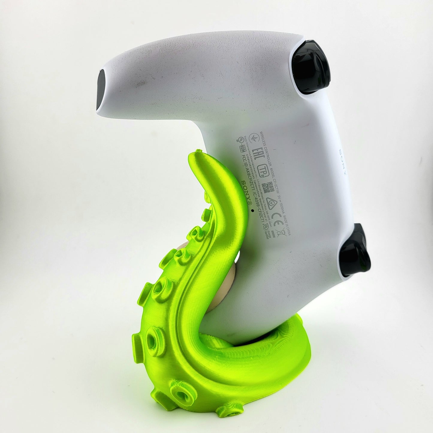 One ps5 controller stand featuring a skull design and green tentacle, 3D printed with high-quality PLA.