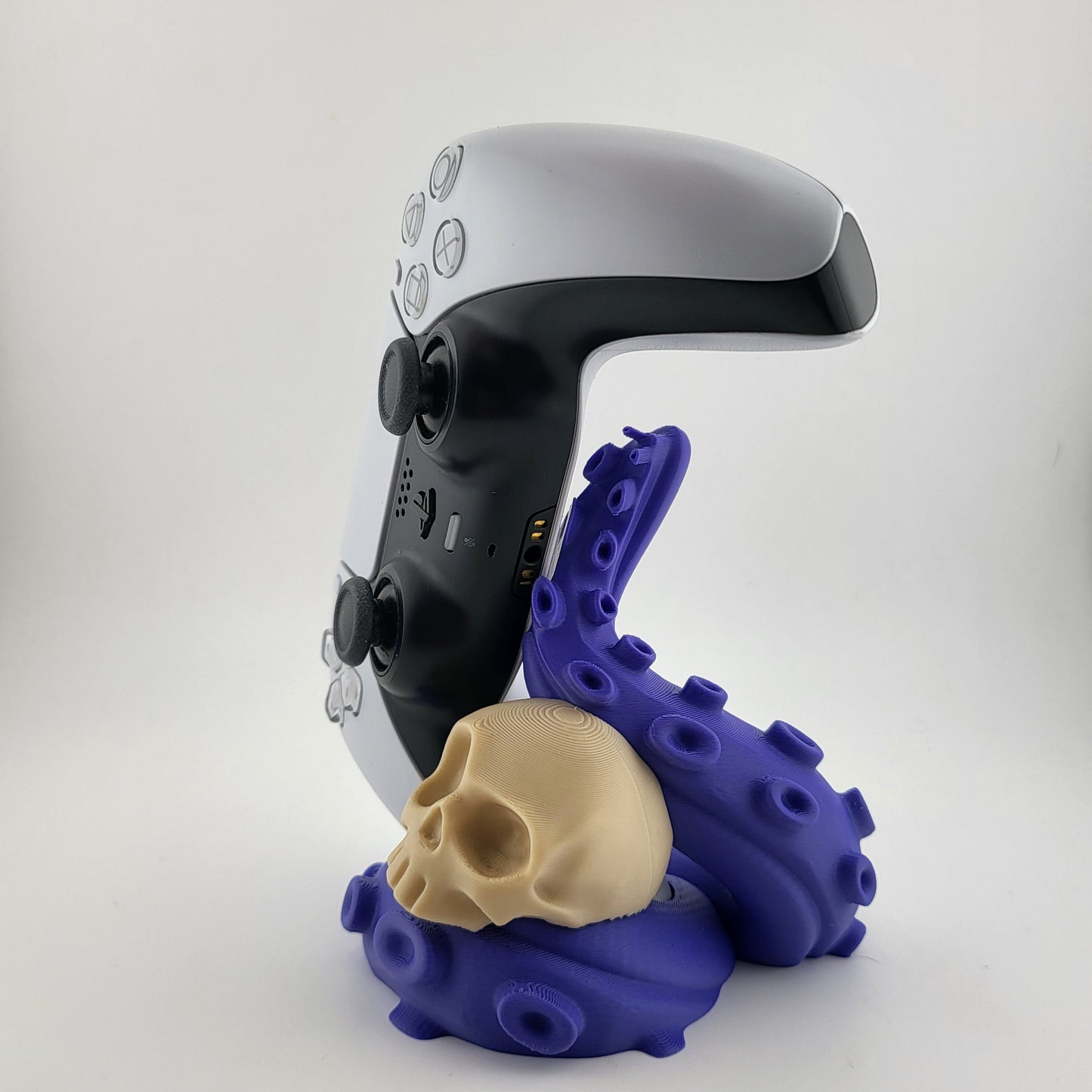 One PS5 controller stand featuring a skull design and purple tentacles, 3D printed with high-quality PLA.