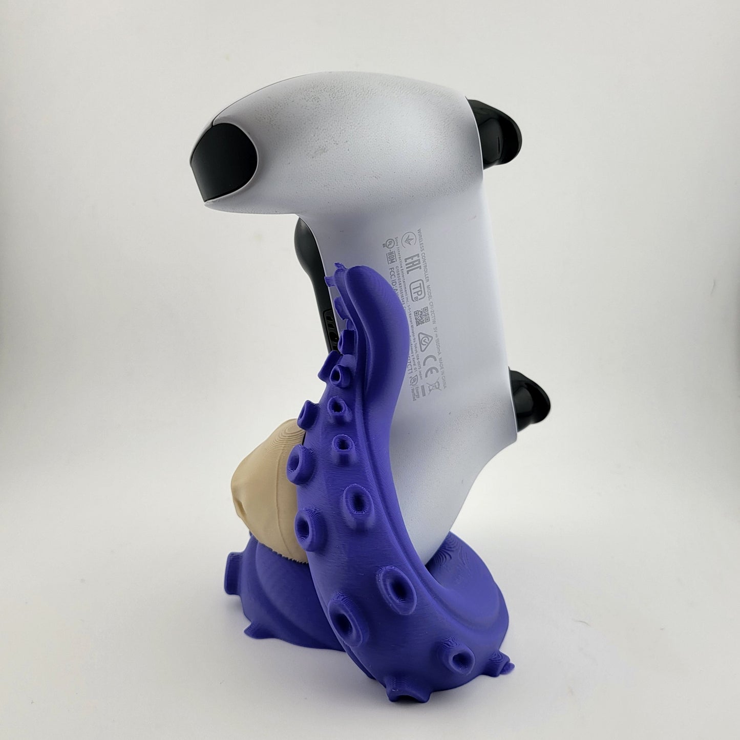 One PS5 controller stand featuring a skull design and purple tentacles, 3D printed with high-quality PLA.