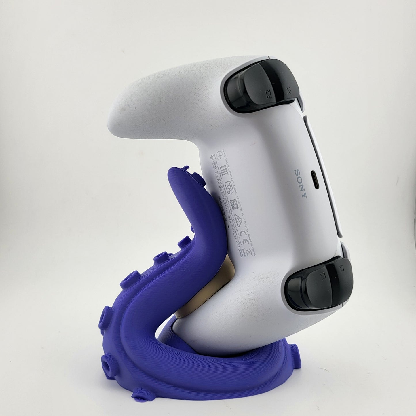 One PS5 controller stand featuring a skull design and purple tentacles, 3D printed with high-quality PLA.