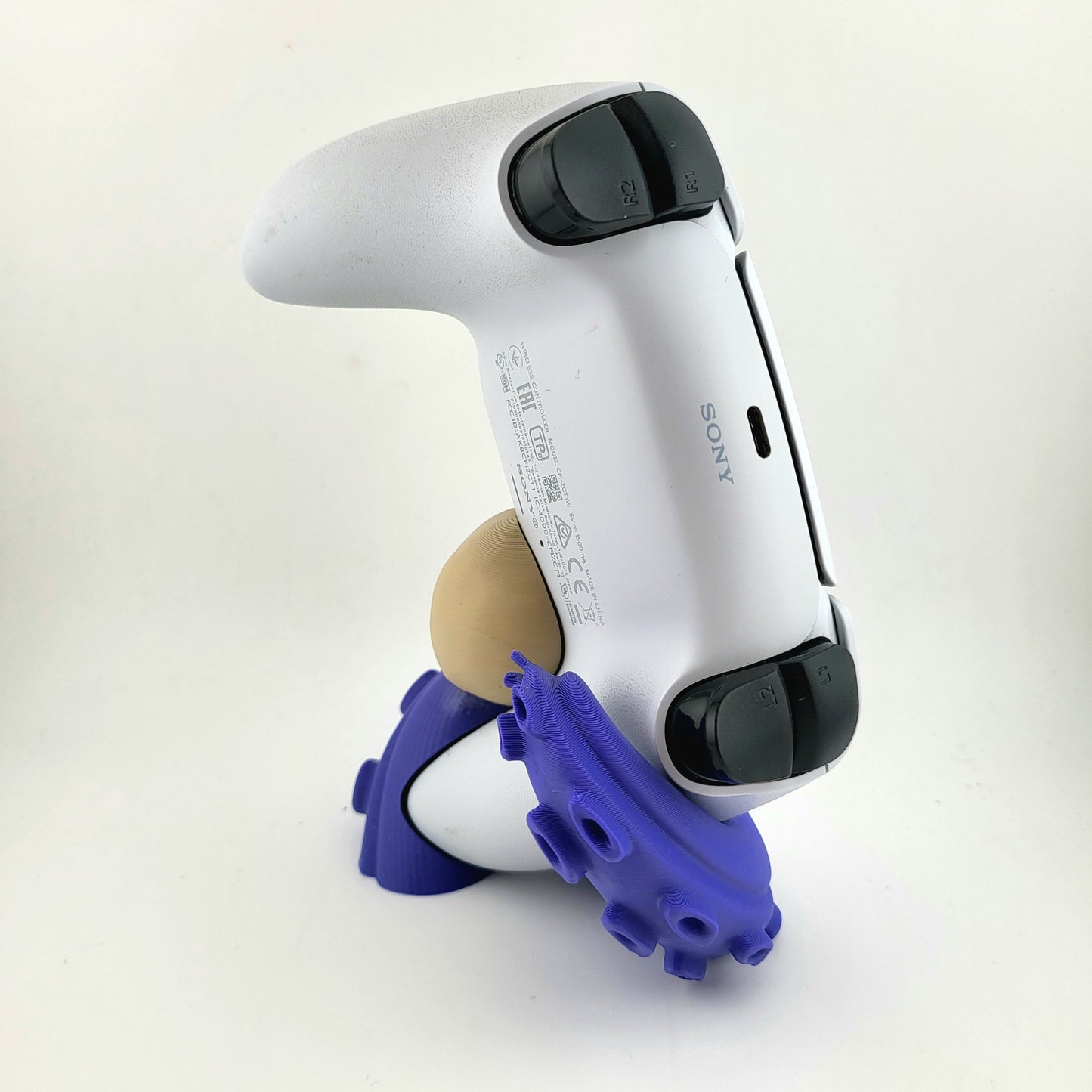One PS5 controller stand featuring a skull design and purple tentacles, 3D printed with high-quality PLA.