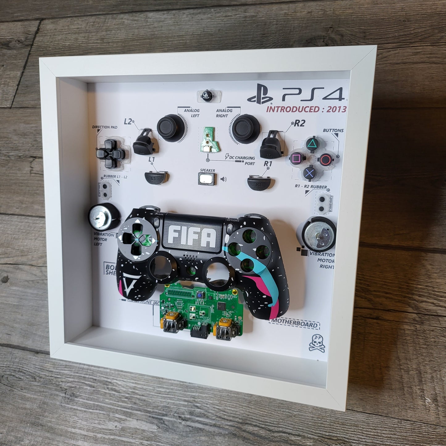 Shadow Box 10x10 with wood frame and polycarbonate glass for wall and Tabletop containing a disassembled controller for Playstation and Nintendo