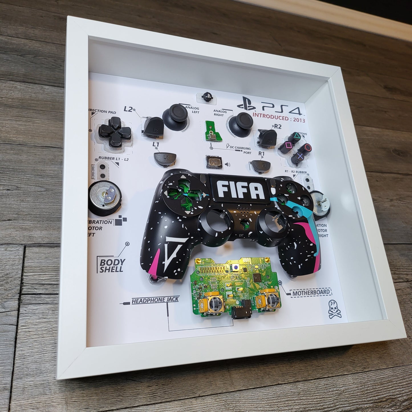 Shadow Box 10x10 with wood frame and polycarbonate glass for wall and Tabletop containing a disassembled controller for Playstation and Nintendo