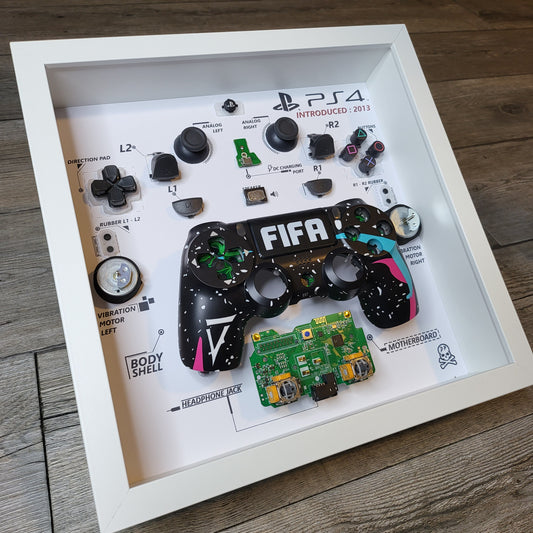 Shadow Box 10x10 with wood frame and polycarbonate glass for wall and Tabletop containing a disassembled controller for Playstation and Nintendo