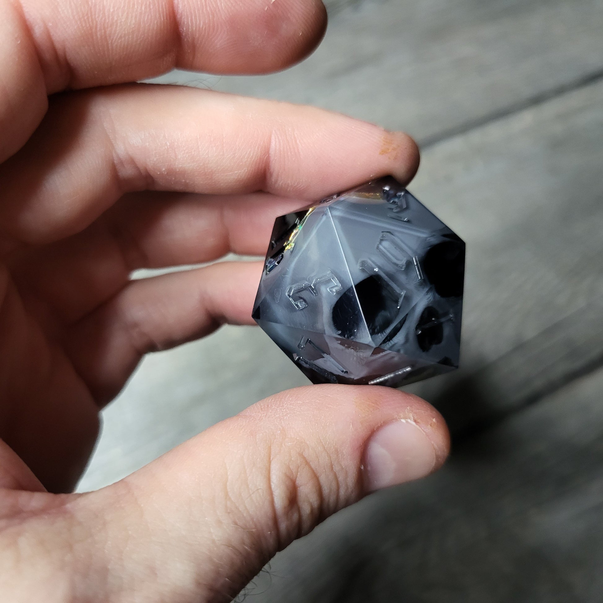 D20 dice in 33 mm format with skull inside for role-playing games for Dungeons and Dragons