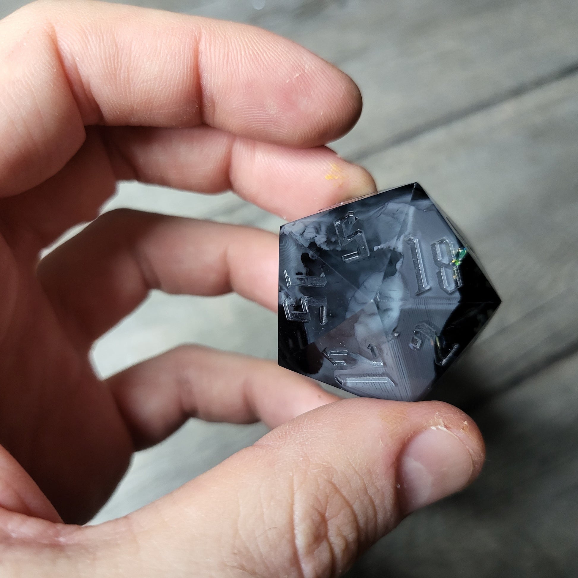 D20 dice in 33 mm format with skull inside for role-playing games for Dungeons and Dragons