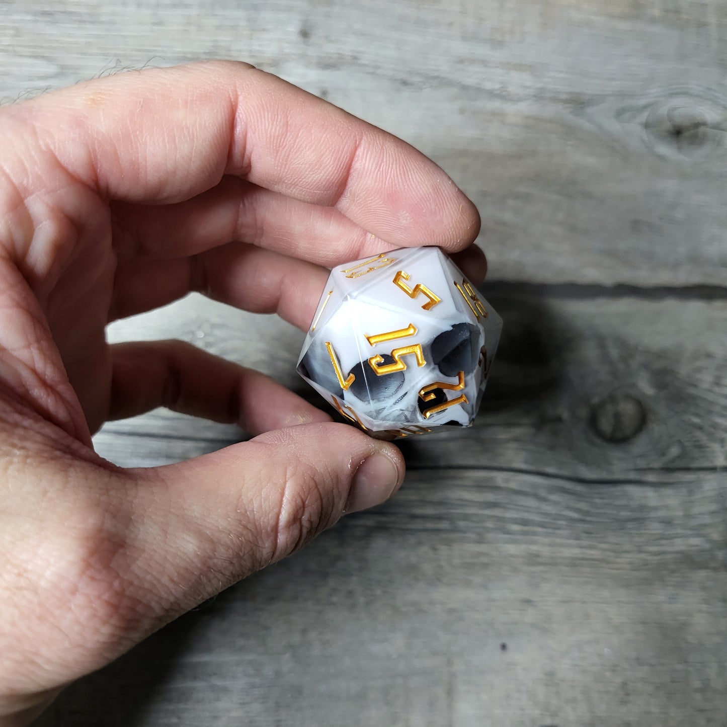 D20 dice in 33 mm format with skull inside for role-playing games for Dungeons and Dragons