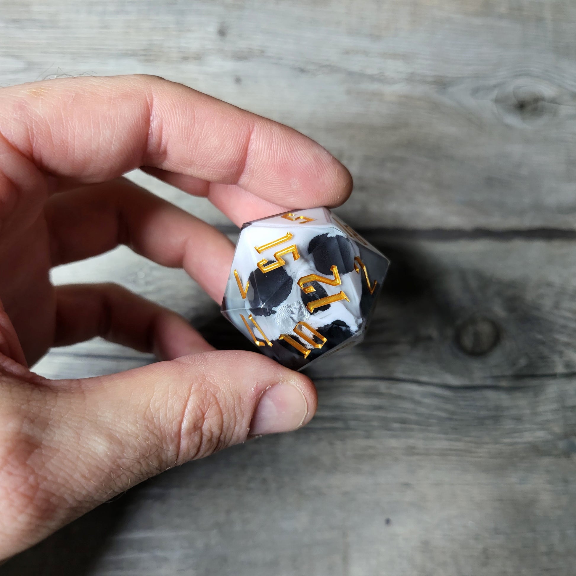 D20 dice in 33 mm format with skull inside for role-playing games for Dungeons and Dragons