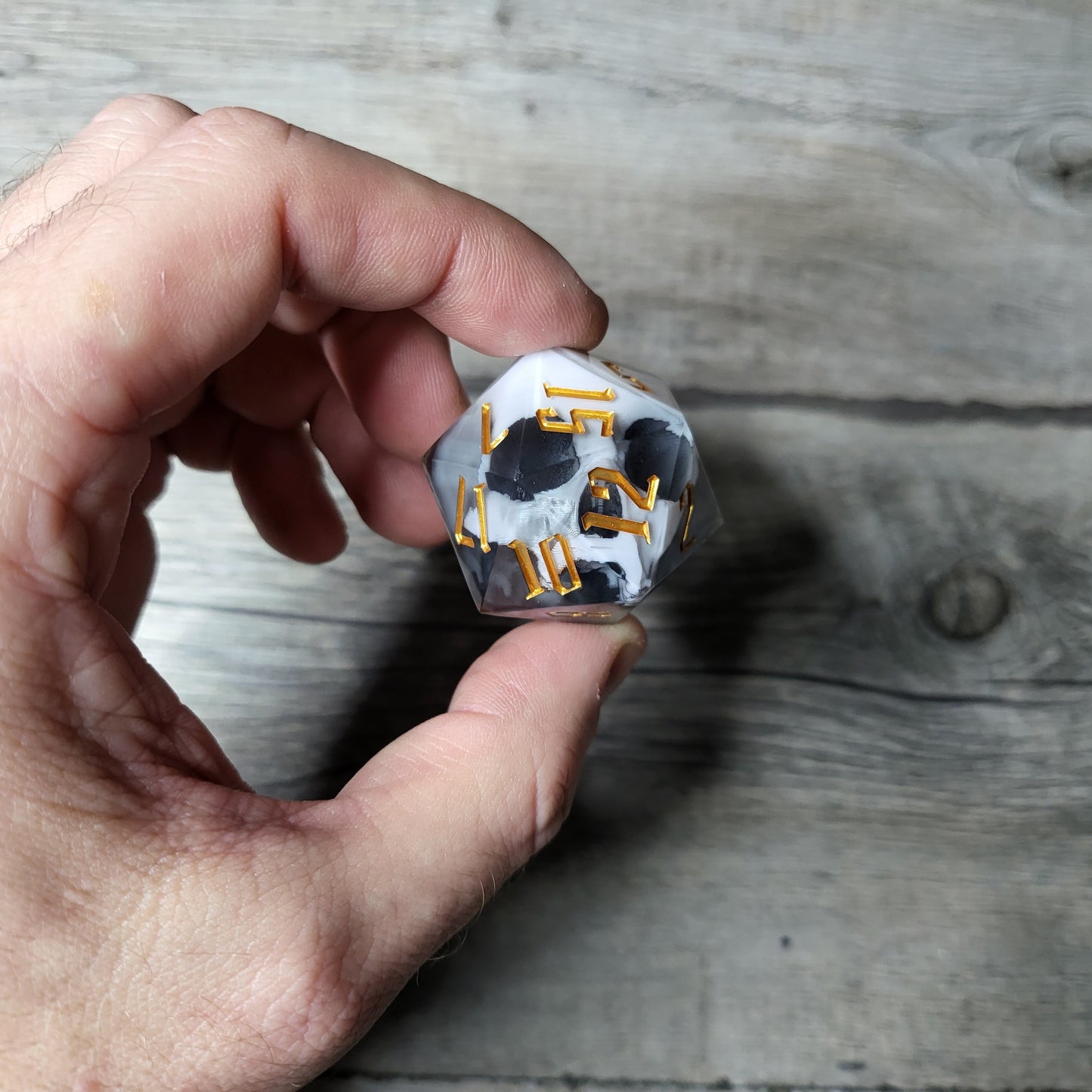 D20 dice in 33 mm format with skull inside for role-playing games for Dungeons and Dragons