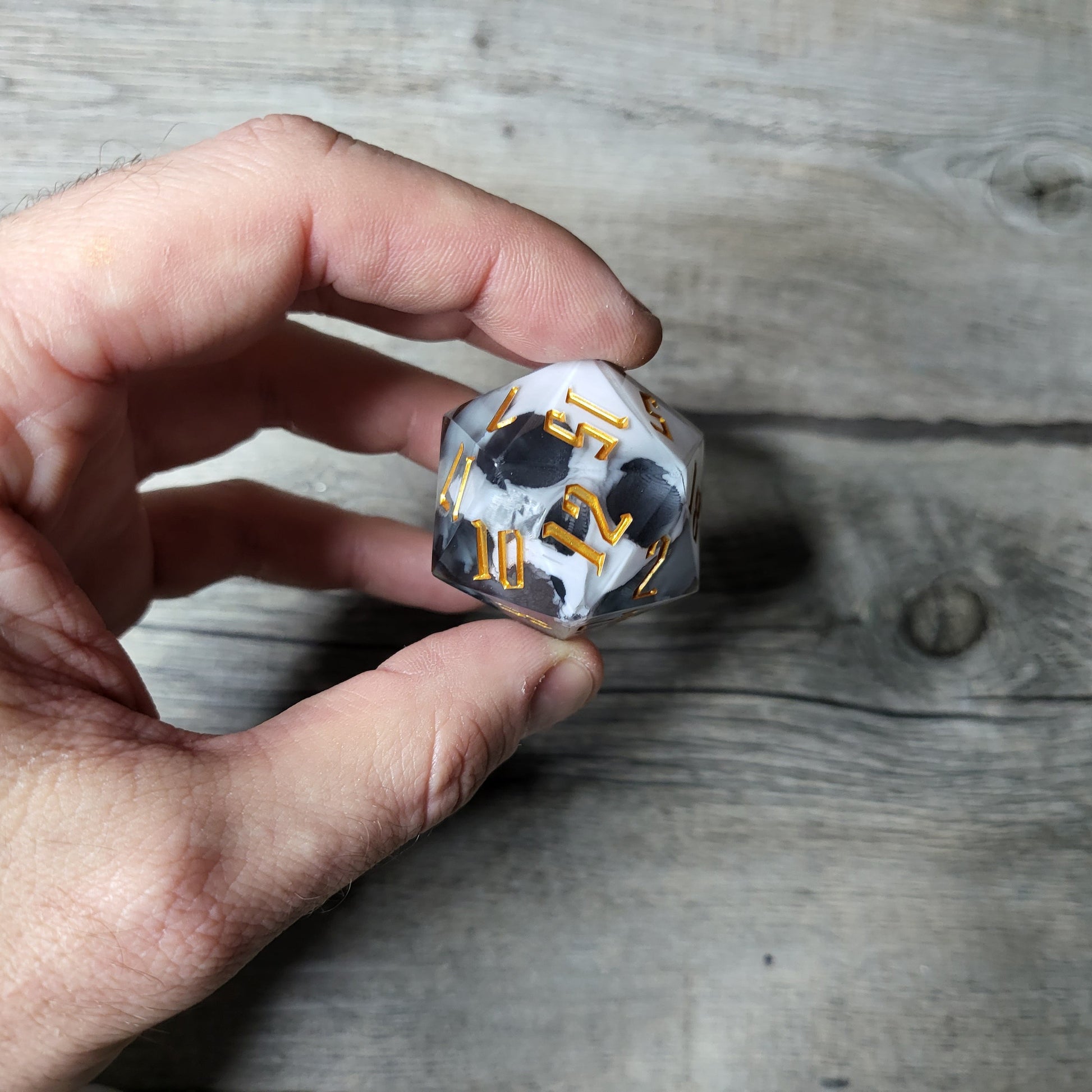 D20 dice in 33 mm format with skull inside for role-playing games for Dungeons and Dragons