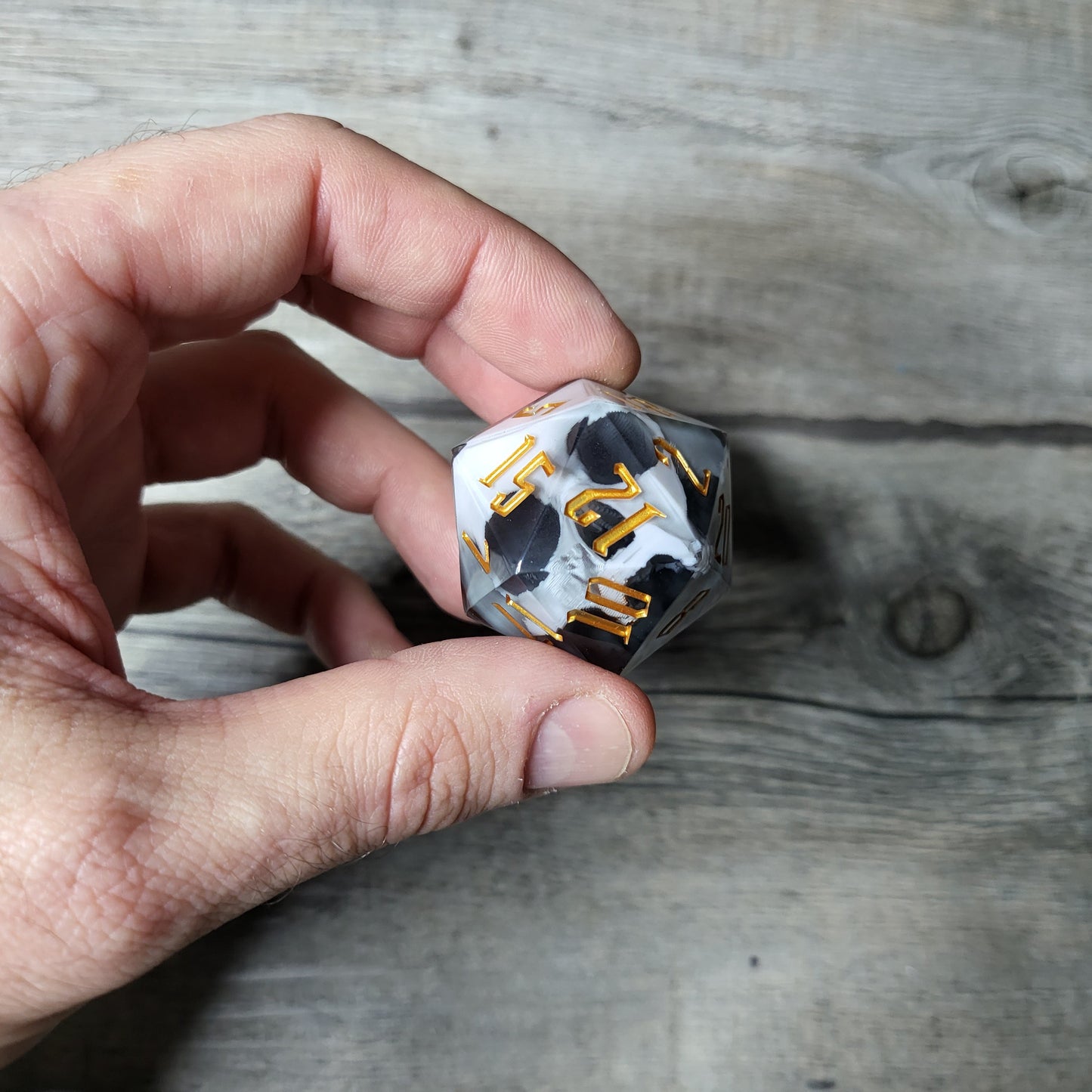 D20 dice in 33 mm format with skull inside for role-playing games for Dungeons and Dragons