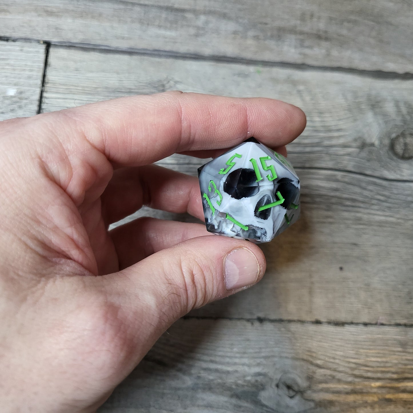 D20 dice in 33 mm format with skull inside for role-playing games for Dungeons and Dragons