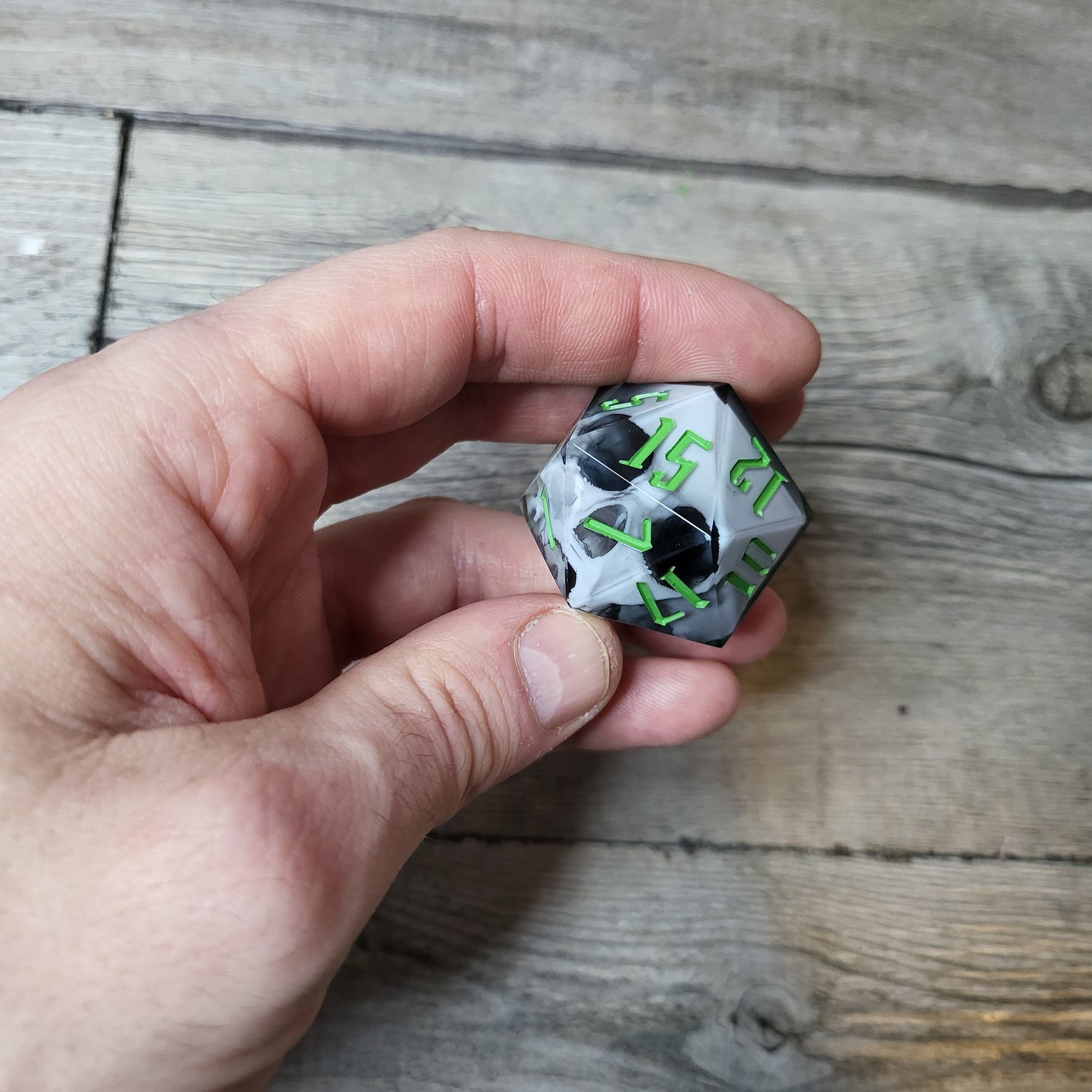 D20 dice in 33 mm format with skull inside for role-playing games for Dungeons and Dragons