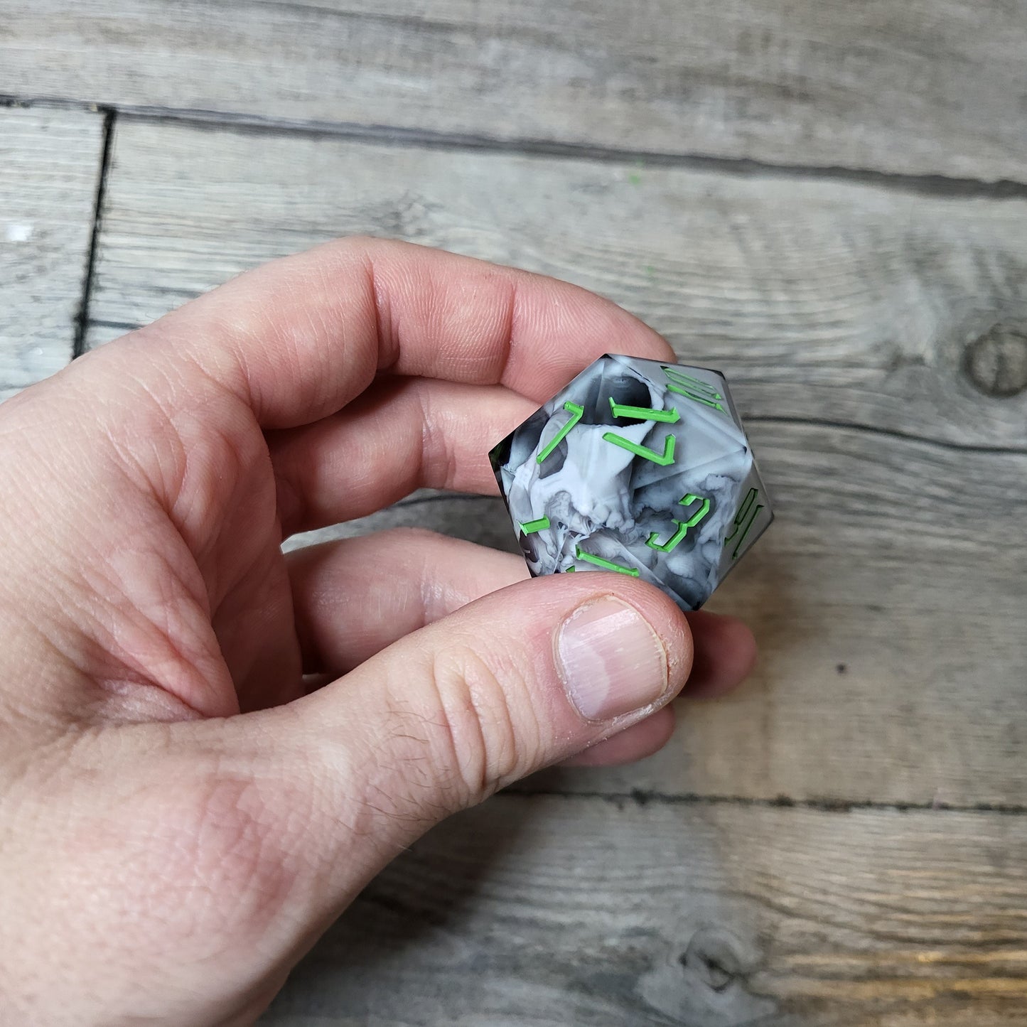 D20 dice in 33 mm format with skull inside for role-playing games for Dungeons and Dragons