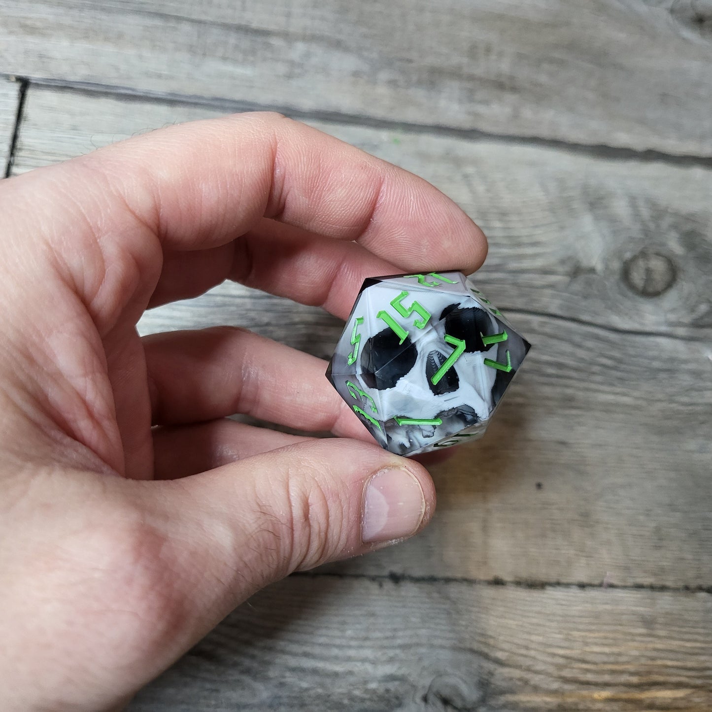 D20 dice in 33 mm format with skull inside for role-playing games for Dungeons and Dragons