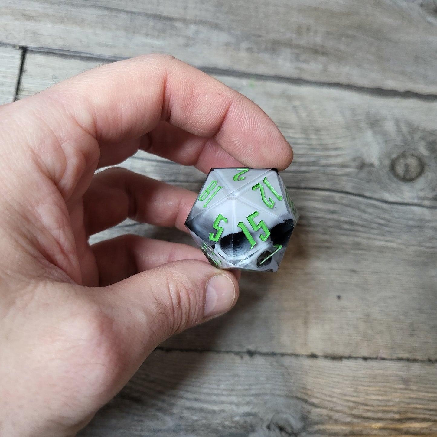 D20 dice in 33 mm format with skull inside for role-playing games for Dungeons and Dragons