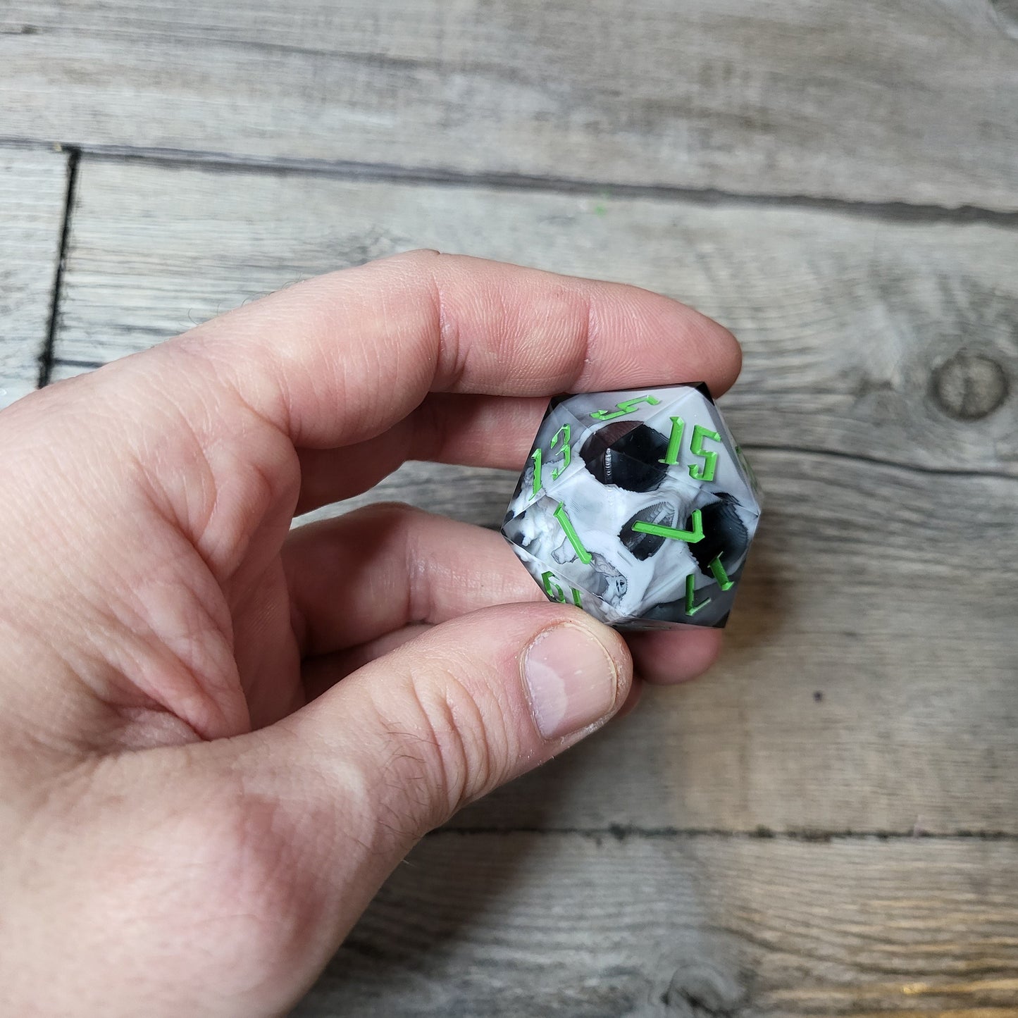 D20 dice in 33 mm format with skull inside for role-playing games for Dungeons and Dragons