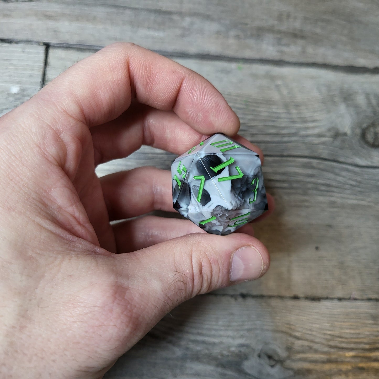 D20 dice in 33 mm format with skull inside for role-playing games for Dungeons and Dragons