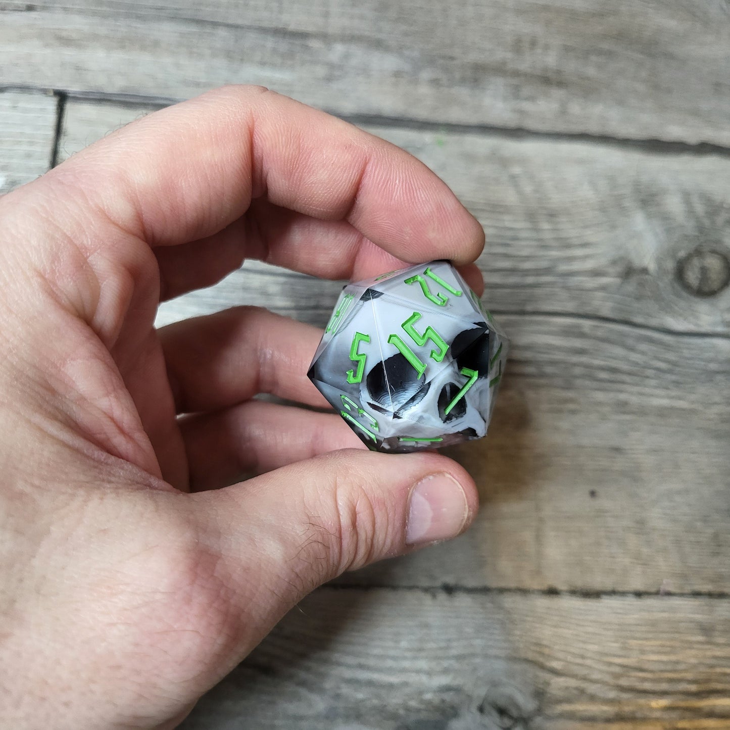 D20 dice in 33 mm format with skull inside for role-playing games for Dungeons and Dragons