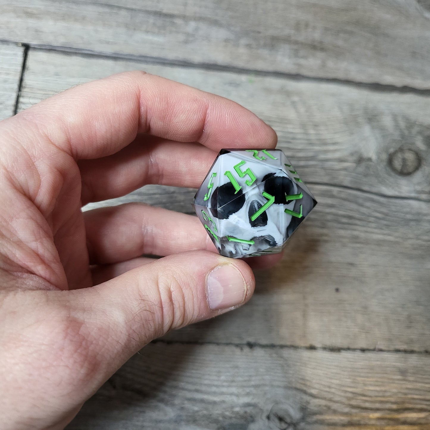 D20 dice in 33 mm format with skull inside for role-playing games for Dungeons and Dragons