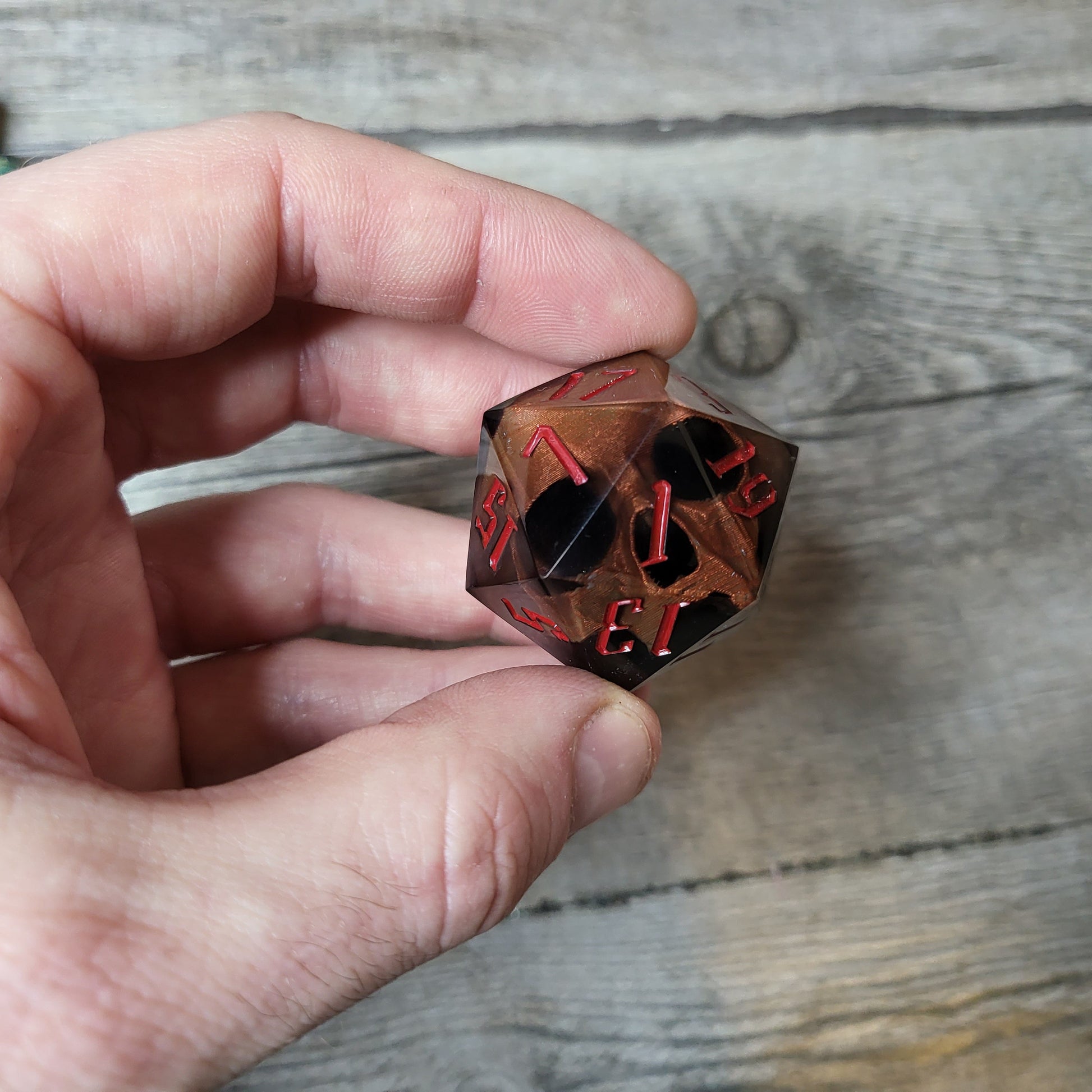 D20 dice in 33 mm format with skull inside for role-playing games for Dungeons and Dragons