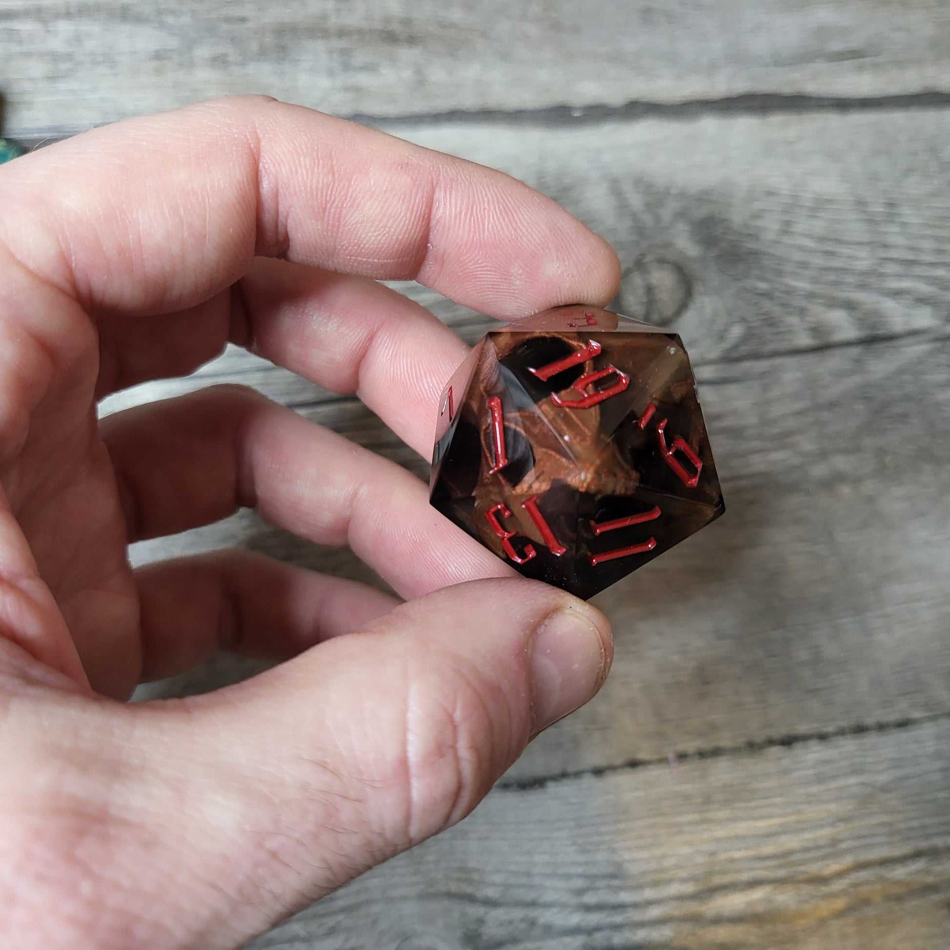 D20 dice in 33 mm format with skull inside for role-playing games for Dungeons and Dragons